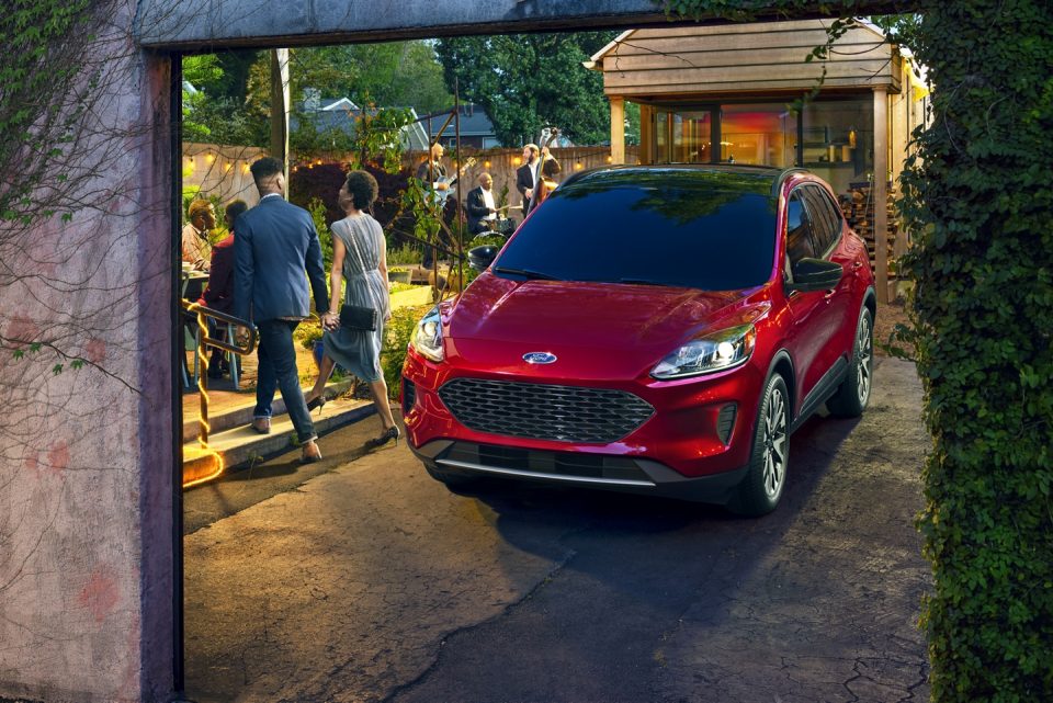 A red 2020 Ford Escape and a well-dressed couple at a party.