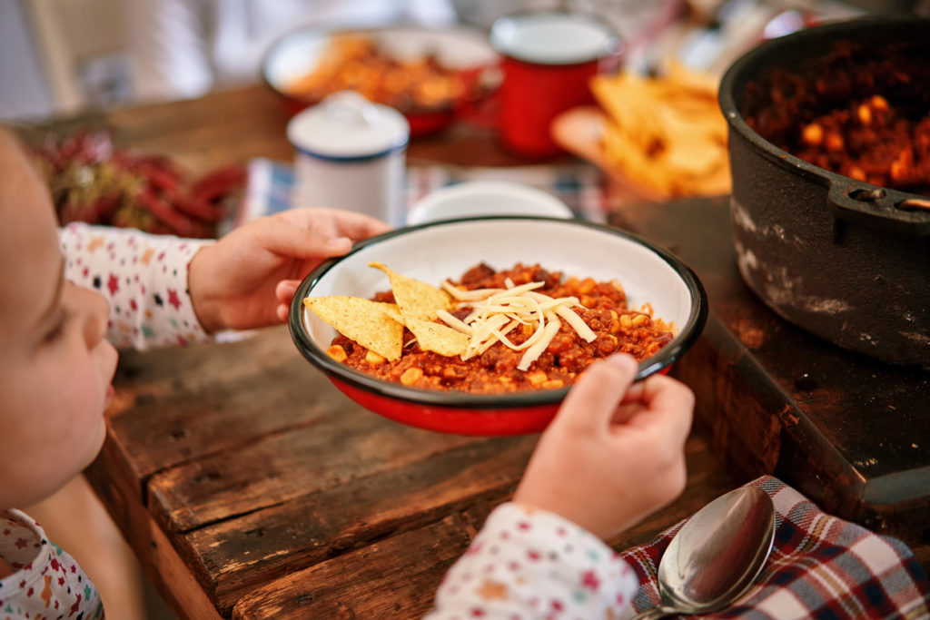 Young Family Eating Chili Con Carne