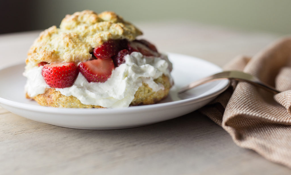 One strawberry shortcake on a small white plate.