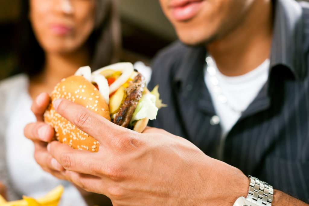 Man in a restaurant eating hamburger