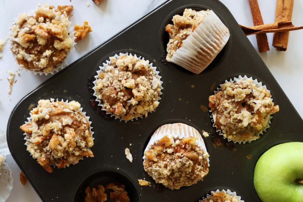 view of muffin baking tray containing homemade apple muffins