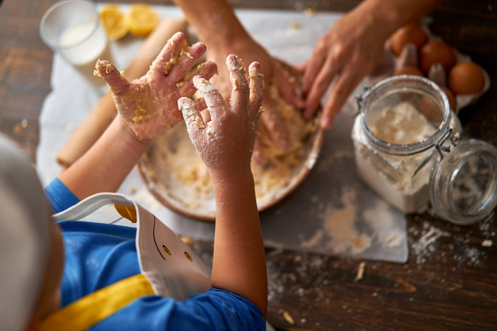 child and mom baking cookies