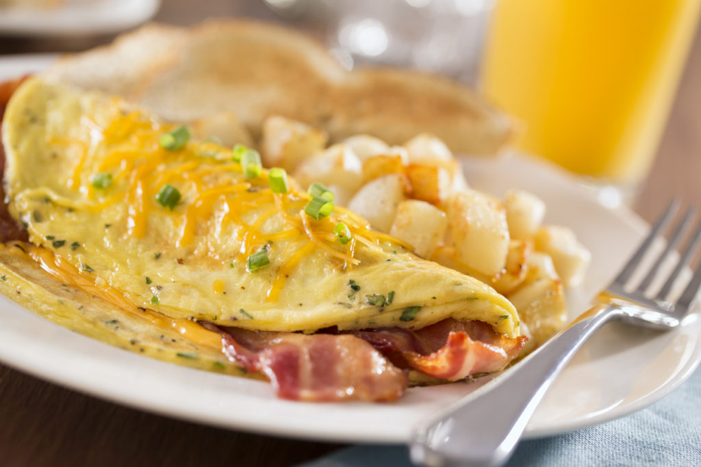 omelette on plate with sides and juice